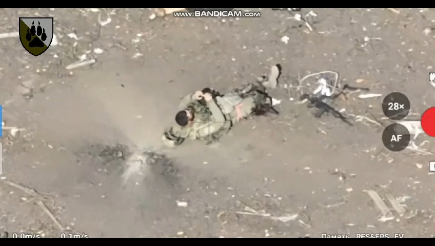 Russian is struck on a walk. Appears to pull grenade from his vest. Video jump cuts to him dead with a large wound on his chest