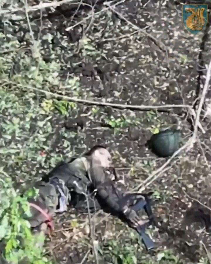Wounded Russian laying on his side with helmet off shoots himself in the head. Moment of shot is skipped