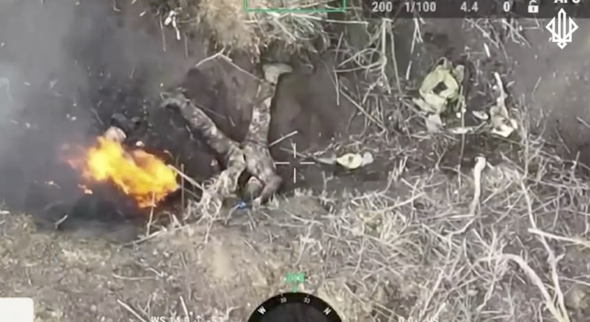 Apparently mentally ill Russian puts himself next to his burning comrade, followed by explosion