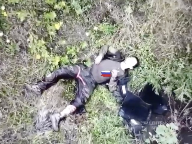 Desperate Russian with all the body armour off puts grenade to his chest